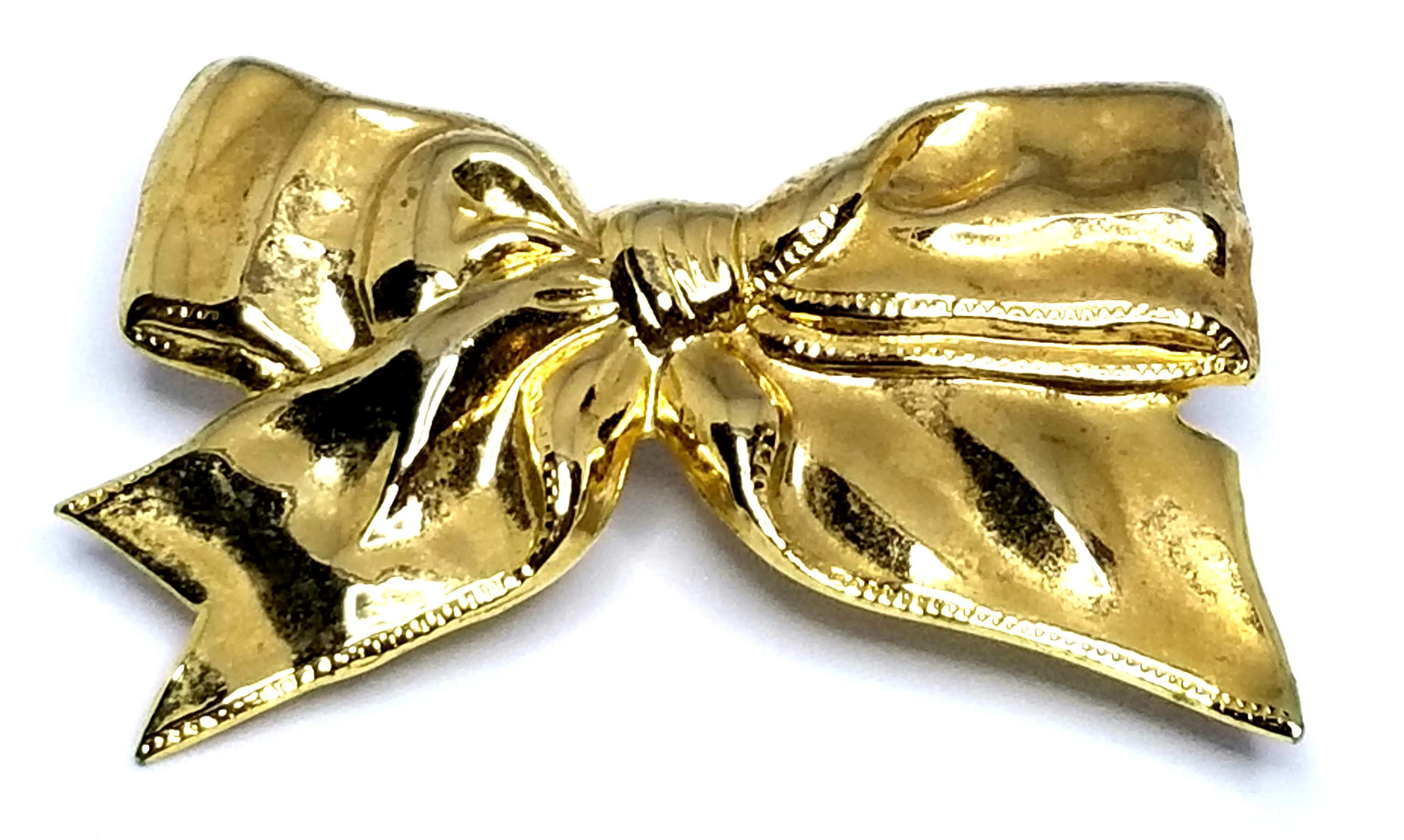 Designer by provenance, scarf clip, bow motif, gold tone, 1 7/8 x 1 1/3 inches.