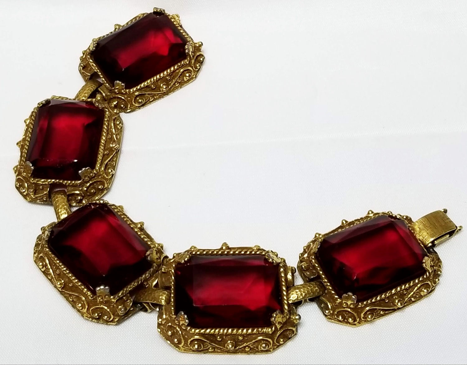Designer by Judy Lee, bracelet, red glass cabochons in gold tone pot metal.
