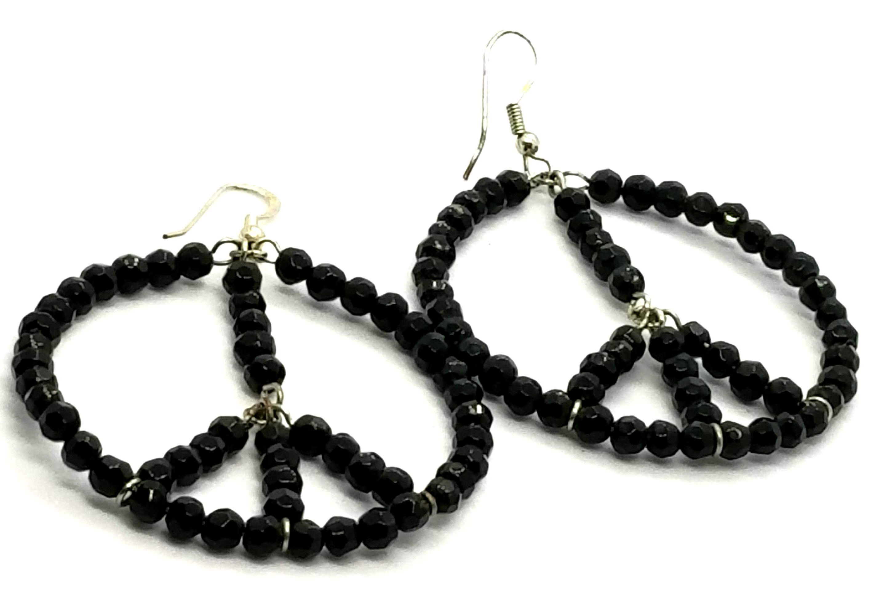 Designer by provenance, earrings, pierced wire drops, peace sign motif, black.