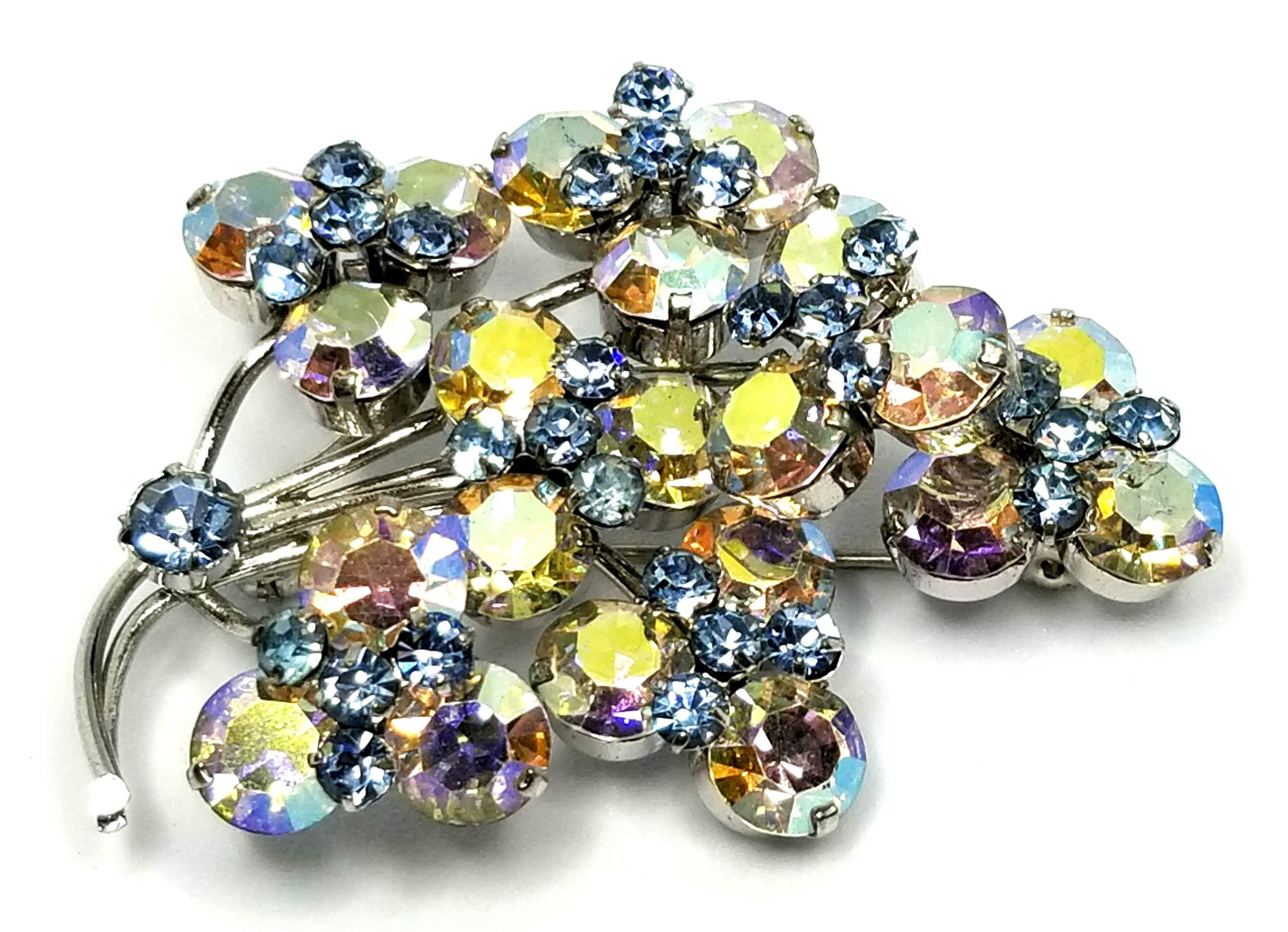 Designer by provenance, brooch, aurora borealis and blue rhinestones.