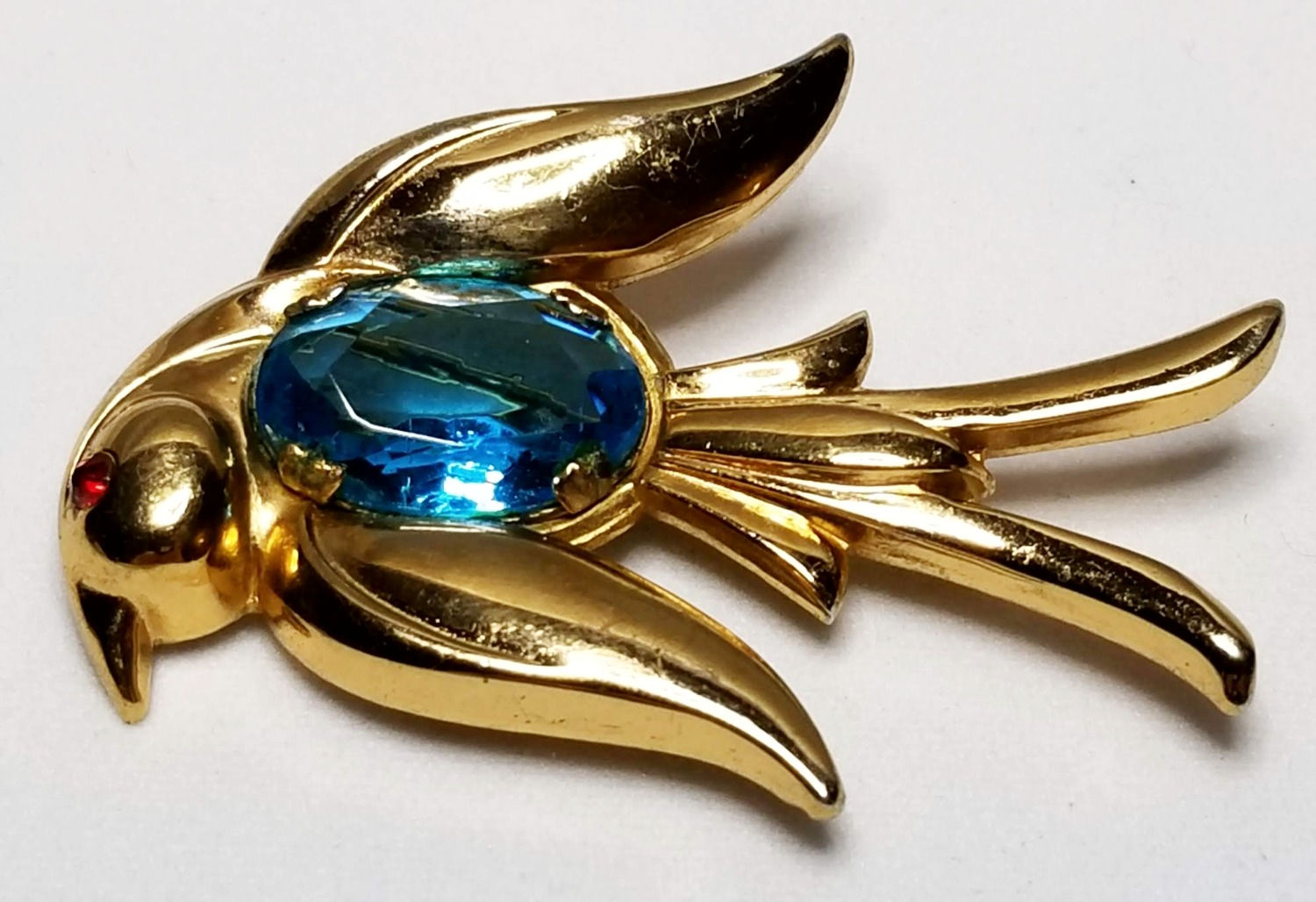 Designer by Coro, brooch, bird motif, blue cabochon in gold tone.
