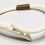Thumbnail: Designer by Eisenberg, bangle, hinged white spring bangle with gold tone.