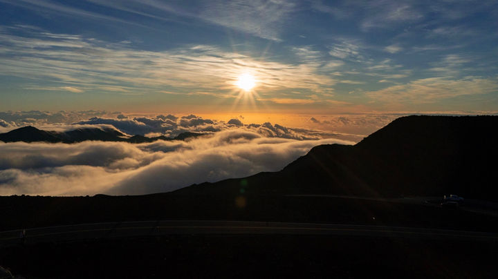 Sunset over a sea of clouds from a mountain peak