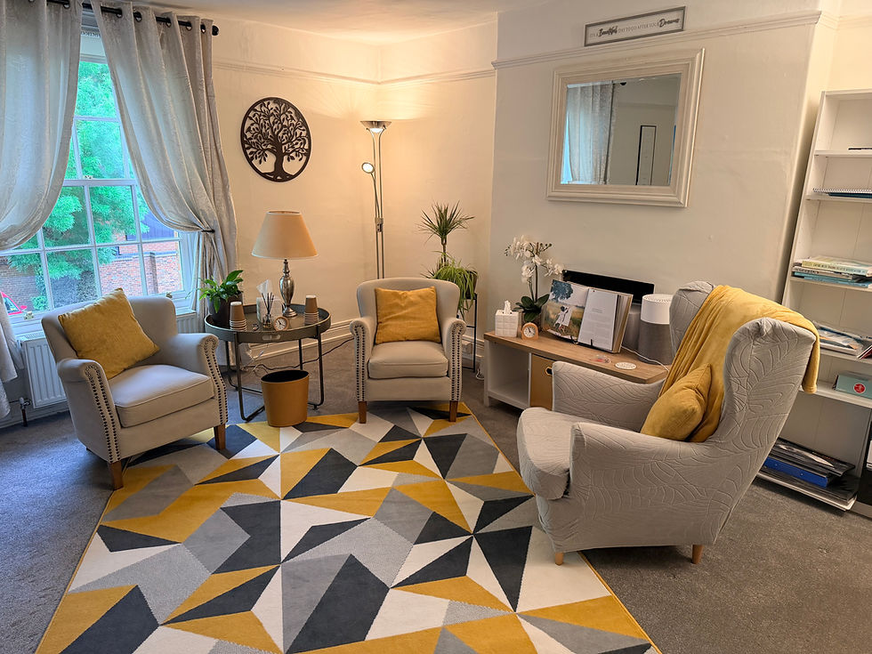 Eye-level view of a quiet counselling office with a comfortable chair and soft lighting