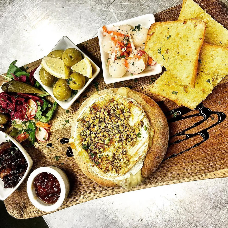 Baked Camembert with olives, prawns, and garlic bread