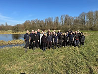 Volunteers and staff smiling in the sunshine on Cornmill Meadows Dragonfly Sanctuary