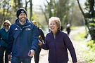 Walk leader and walking laughing while walking