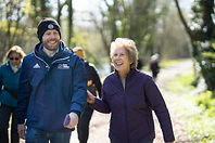 Walk leader and walking laughing while walking