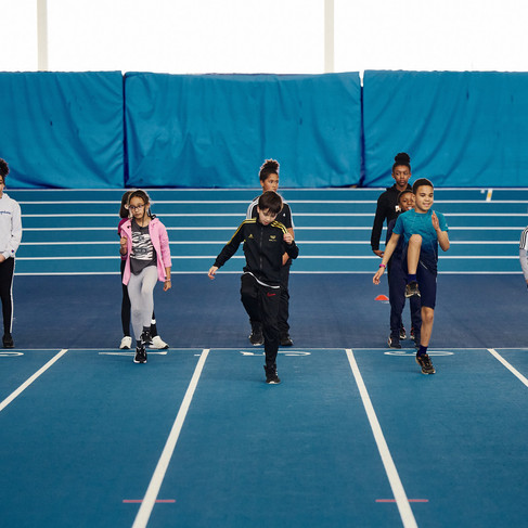 Kids running along a track