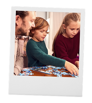 An ADHD father enjoying putting a puzzle together with his neurodivergent children