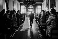 Black and white wedding aisle The Ebell Los Angeles wedding floral installation chandelier and arch 
