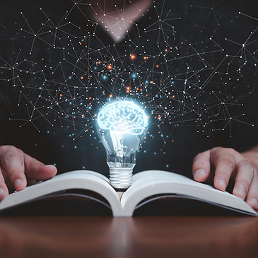 vecteezy_glowing-lightbulb-with-virtual-brain-on-open-book-and_7126175.jpg