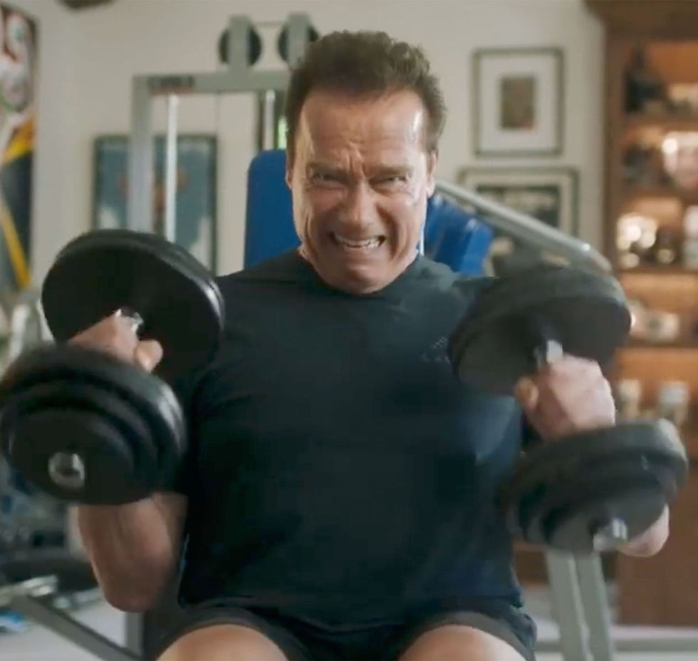 Arnold Schwarzenegger lifting dumbbells