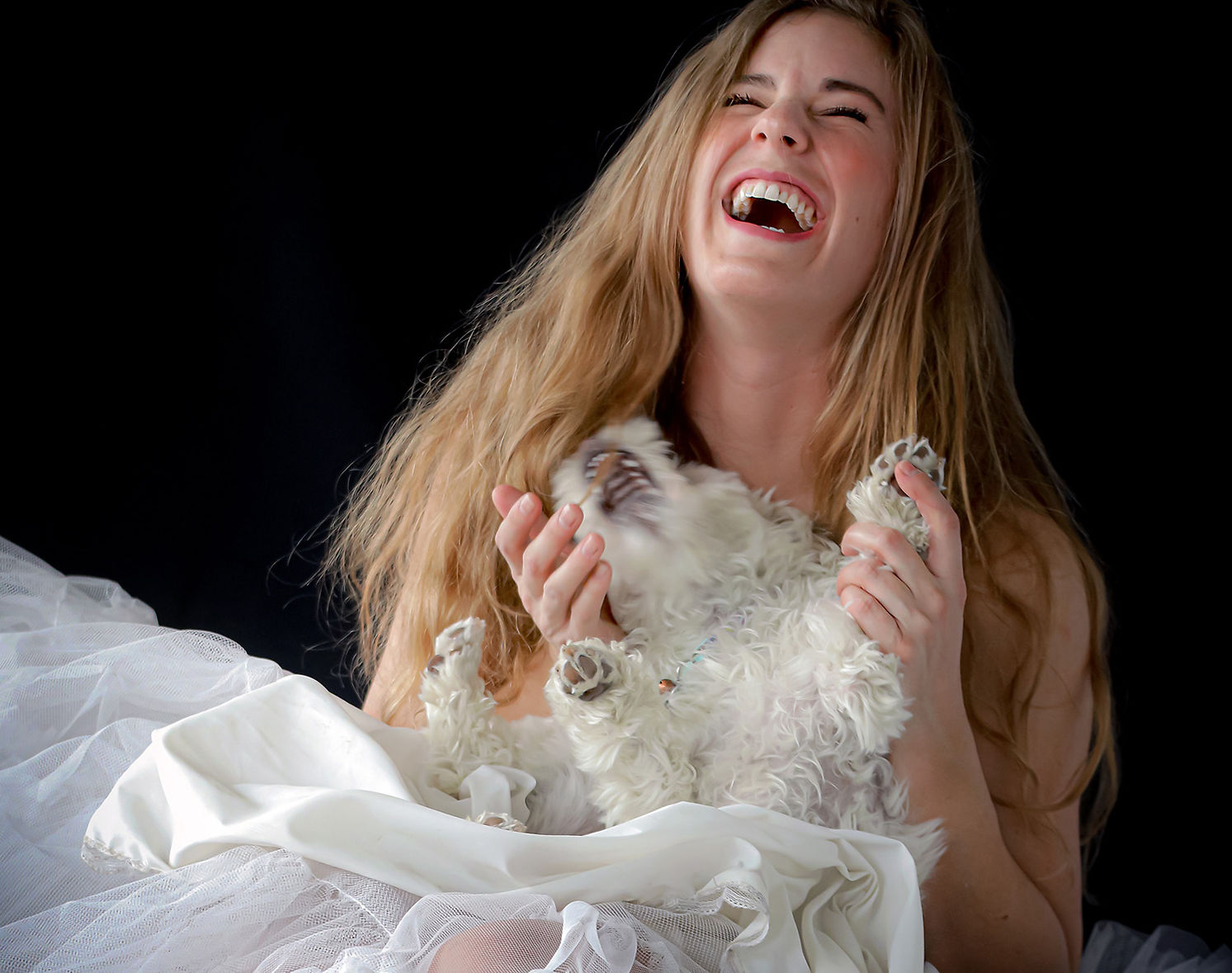 Girl laughing with dog