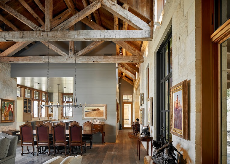 Open living space with high ceiling showcasing rustic reclaimed wooden beams.