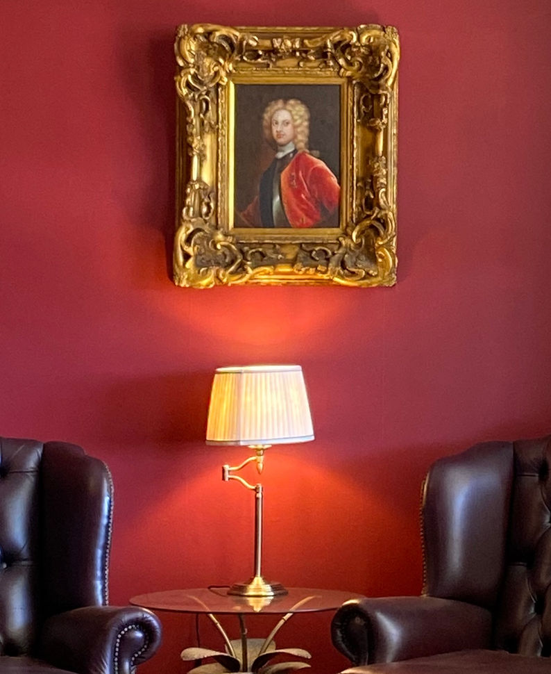 Opulent guest library furnished with stunning antiques and artwork and sumptuous colour