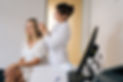 Side view of female trichologist making diagnosis of structure and condition of blonde wom