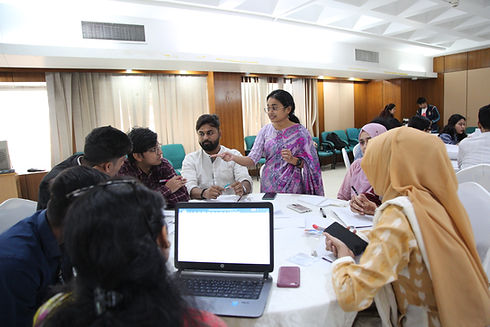 Group of people sat around a table discussing during a workshop