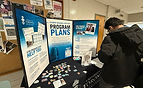 Students visiting the UofT Mississauga Career Centre booth with the Program Plans Board de
