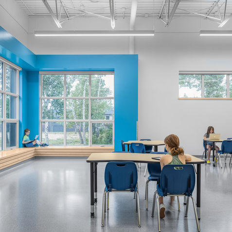 Mitchell Elementary School - Learning commons space with tables and chairs