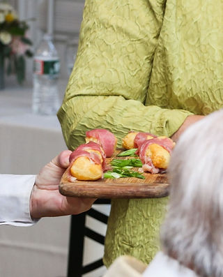 close-up of an Easy Entertaining employee serving appetizers at an event