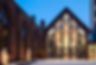 Exterior of the Pavilion at Grace in the winter with snow and lights on the trees outside