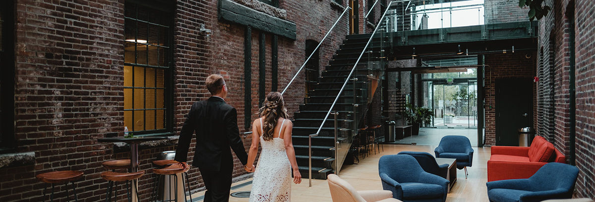 Just married couple walking out of the Atrium at Rising Sun Mills
