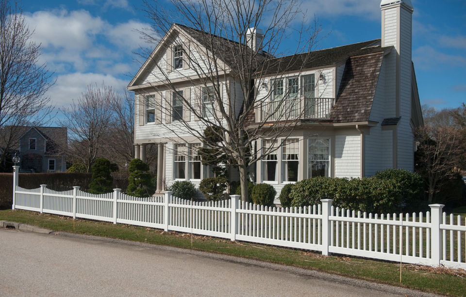 example of work, short white picket fence in front yard of a large suburban house