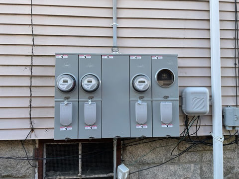 Close up of breaker boxes on side of a house