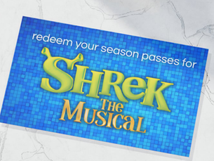A bright blue card that says redeem your season pass for shrek the musical lays on a marble surface.