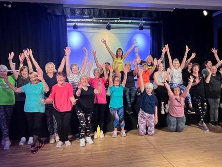 Group of ladies with arms in the air