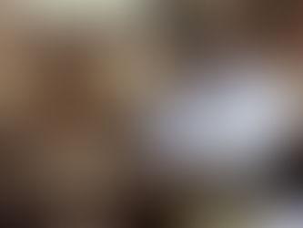 A man holds tablets on a rocky hill, surrounded by a crowd in a desert. A man in a blue shirt reads a book to an attentive audience indoors.