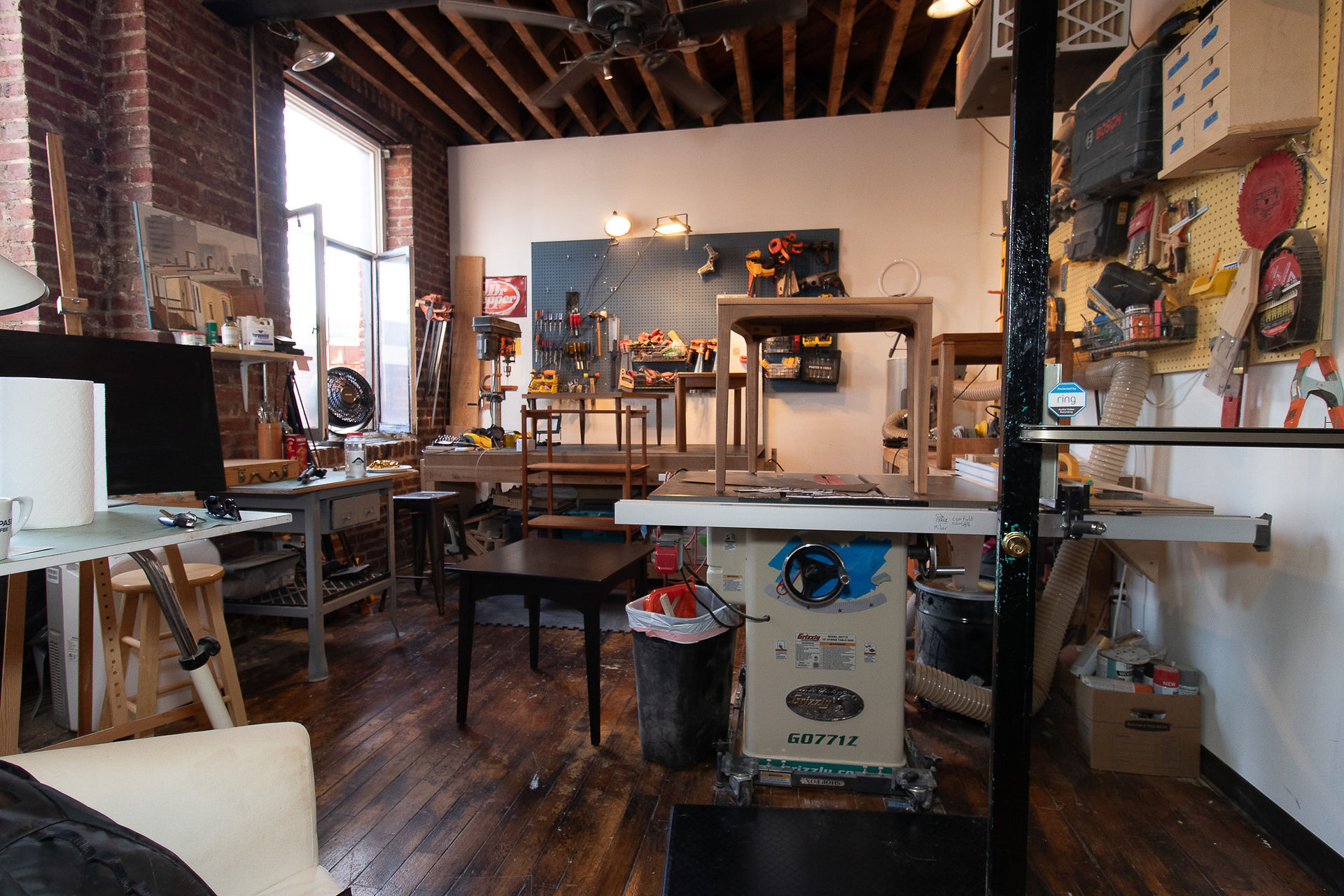 Woodworking tools and finished furniture in Brian Hughes’ studio.