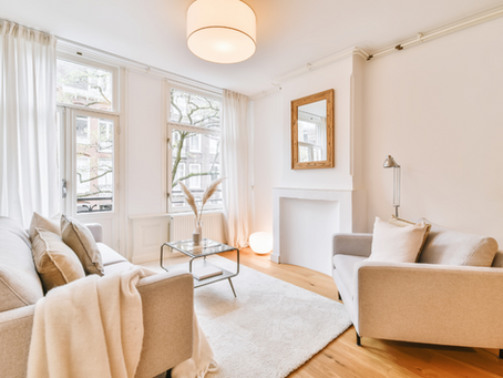 Warm neutral living room with gleaming hardwood floors
