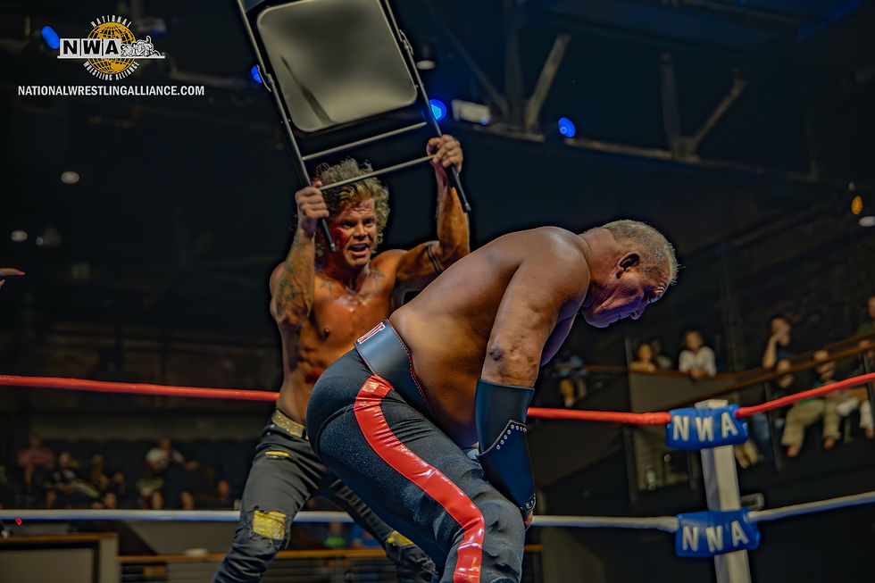 Daisy Kills Slams a chair into the back of Baron Von Storm.