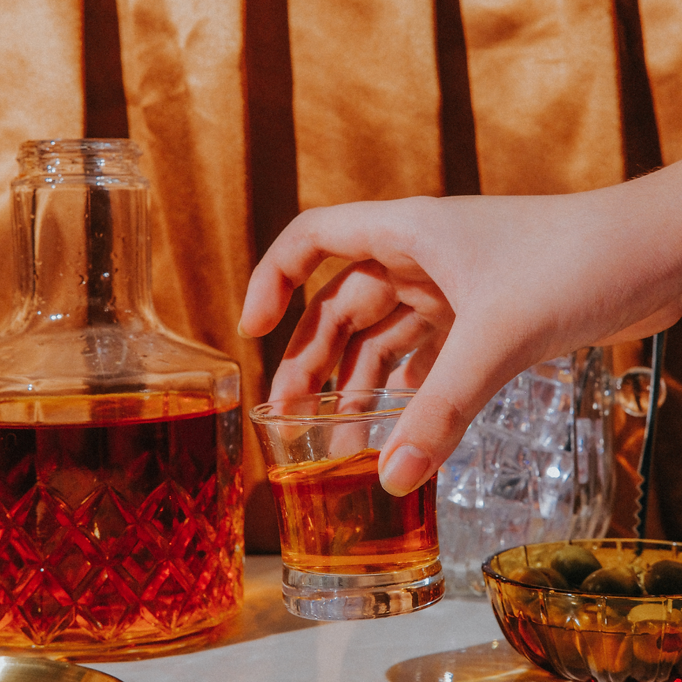 glass or rum with a hand holding it