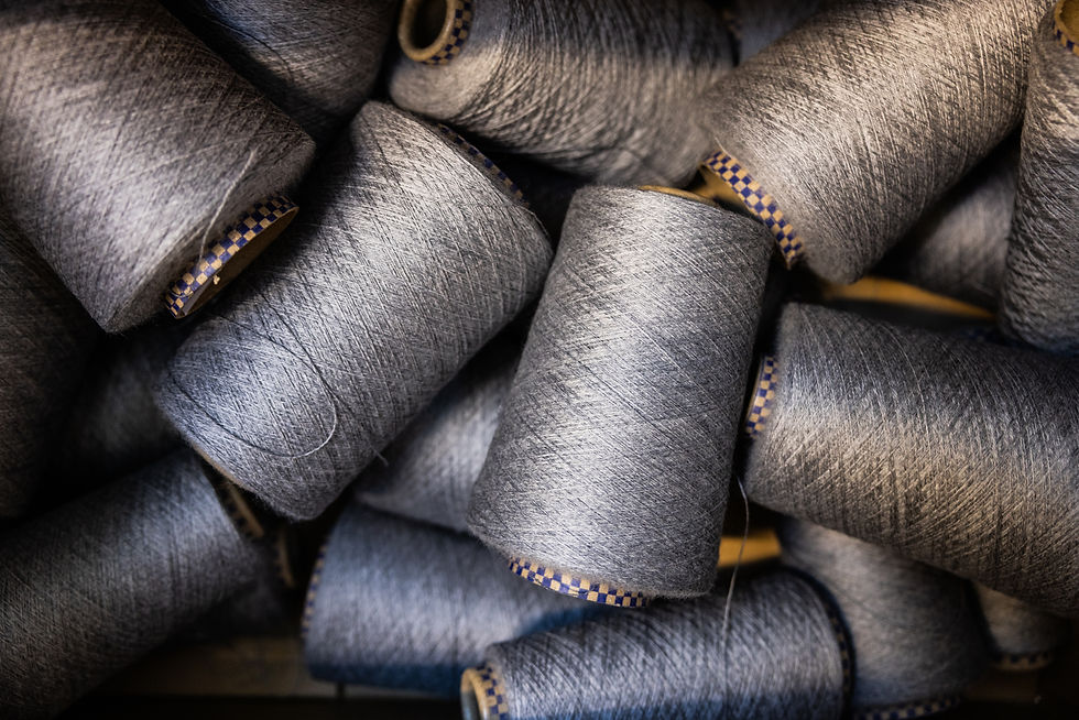 Wool yarn spools prepared before weaving in an Italian textile workshop