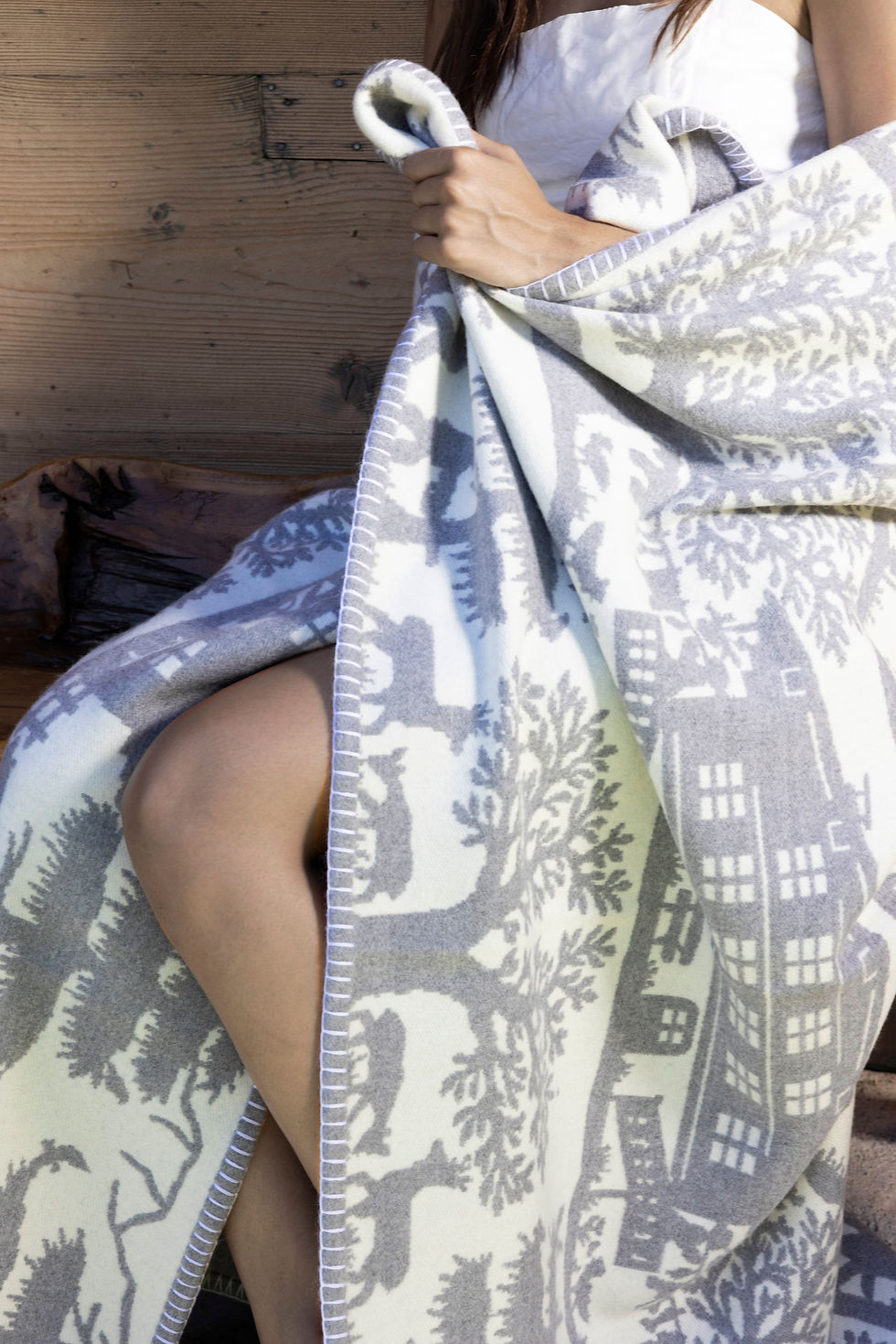 Cashwool luxury throw styled on outdoor in natural light creating a calm tactile atmosphere