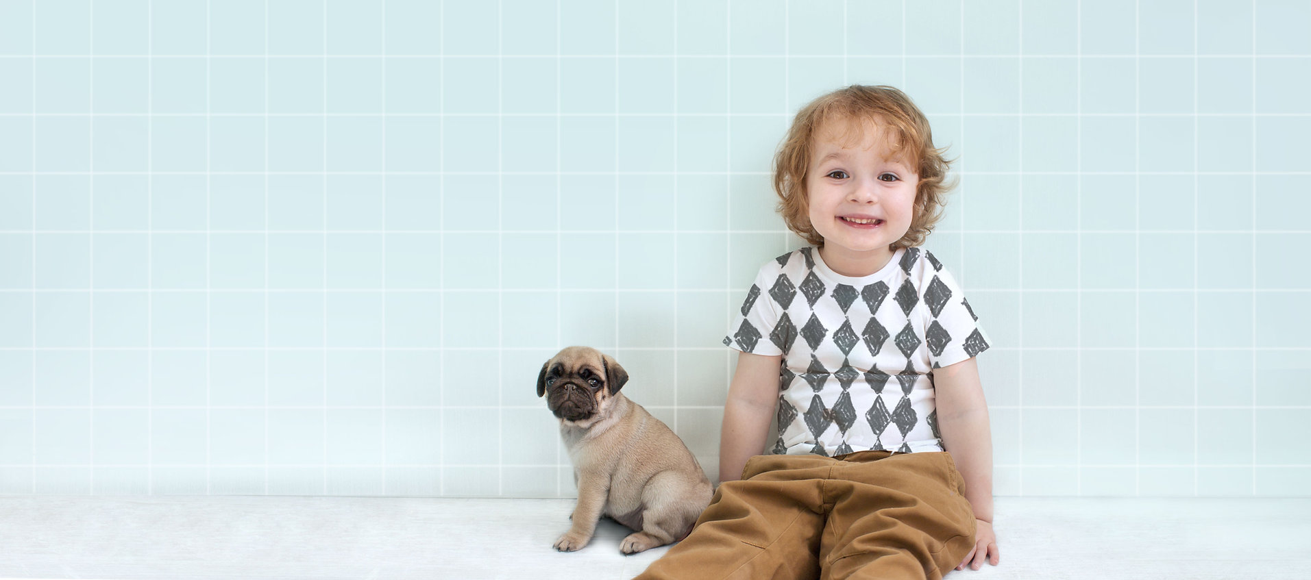 Boy with Pug Puppy