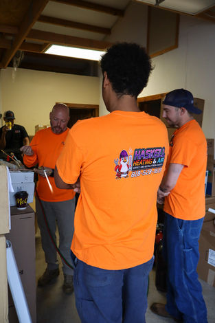 Certified HVAC technicians receiving advanced AC unit maintenance training at the Haskell HVAC facility in Banner Elk.