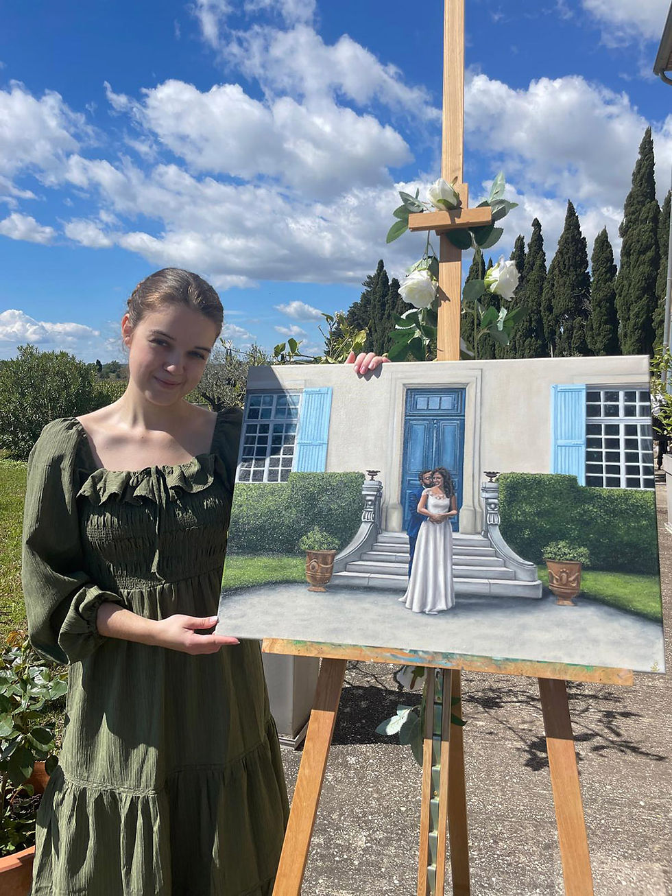 Live painter Salomé setting outdoors, next to easel with painting of wedding couple