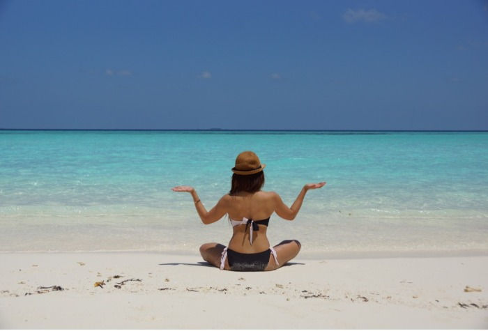 Girl sunbathing by the sea