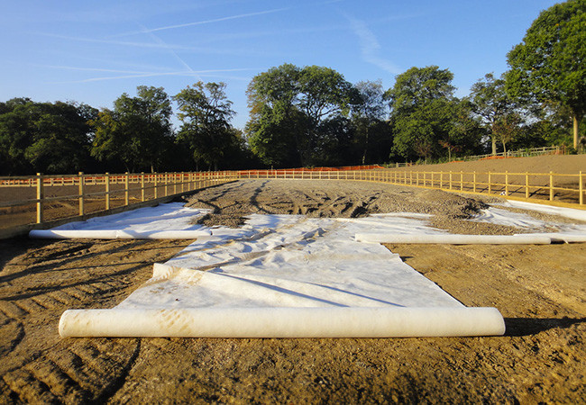 Stone base incorporation into equestrian arena/track by Agrostis