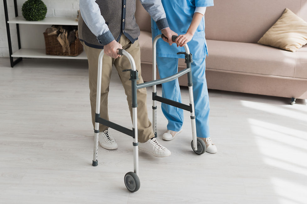 Caregiver helping an elderly man with a walker