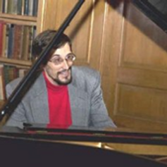 Michael Hammer sitting at piano