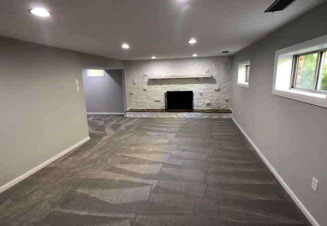 New Gray Carpet, Gray Paint and white Trim. This basement went from an unfinished space to a clean and crisp usable rec room. To save on cost the brick was painted and sealed and more budget was provided toward better lighting.
