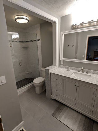 If you can believe it, this used to be two completely separate rooms. A very common theme that's here to stay is opening up your bath space so you are no longer cramped. The bathroom couldn't be quite opened up all the way because of some existing plumbing. A creative alternative is to add some trim work to cover this and still give a great aesthetic appearance. This is a great example of what a professional team can do in a residential bathroom.