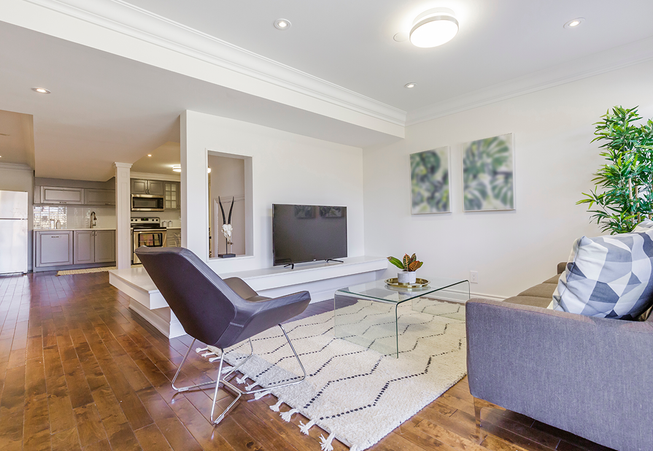 A great budget choice is to consider laminate or vinyl plank flooring over wood floors. Oftentimes the cost is nearly half with less maintenance and little to no drawbacks. The key is spending the budget on a higher quality Laminate or LVP. White walls, white trim and white ceilings couldn't provide a cleaner look than the color choices chosen for this formal living room renovation..