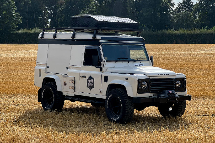 land rover converted in a field