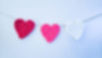 The beginner friendly crochet heart garland displayed hanging with jute.